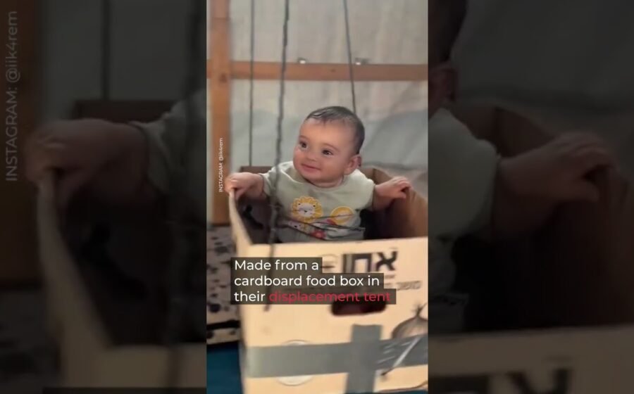 Gaza baby enjoys cardboard swing in displacement tent