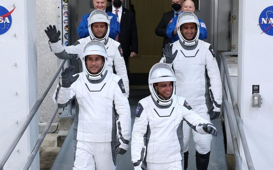 Crew docks at space station with astronaut who'll miss birth of 3rd child